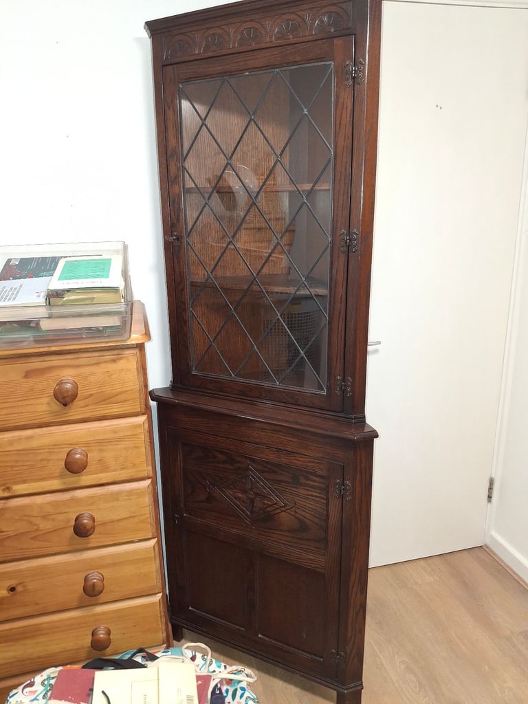 The Jaycee Vintage Oak Corner Display Cabinet is used but in very good condition.