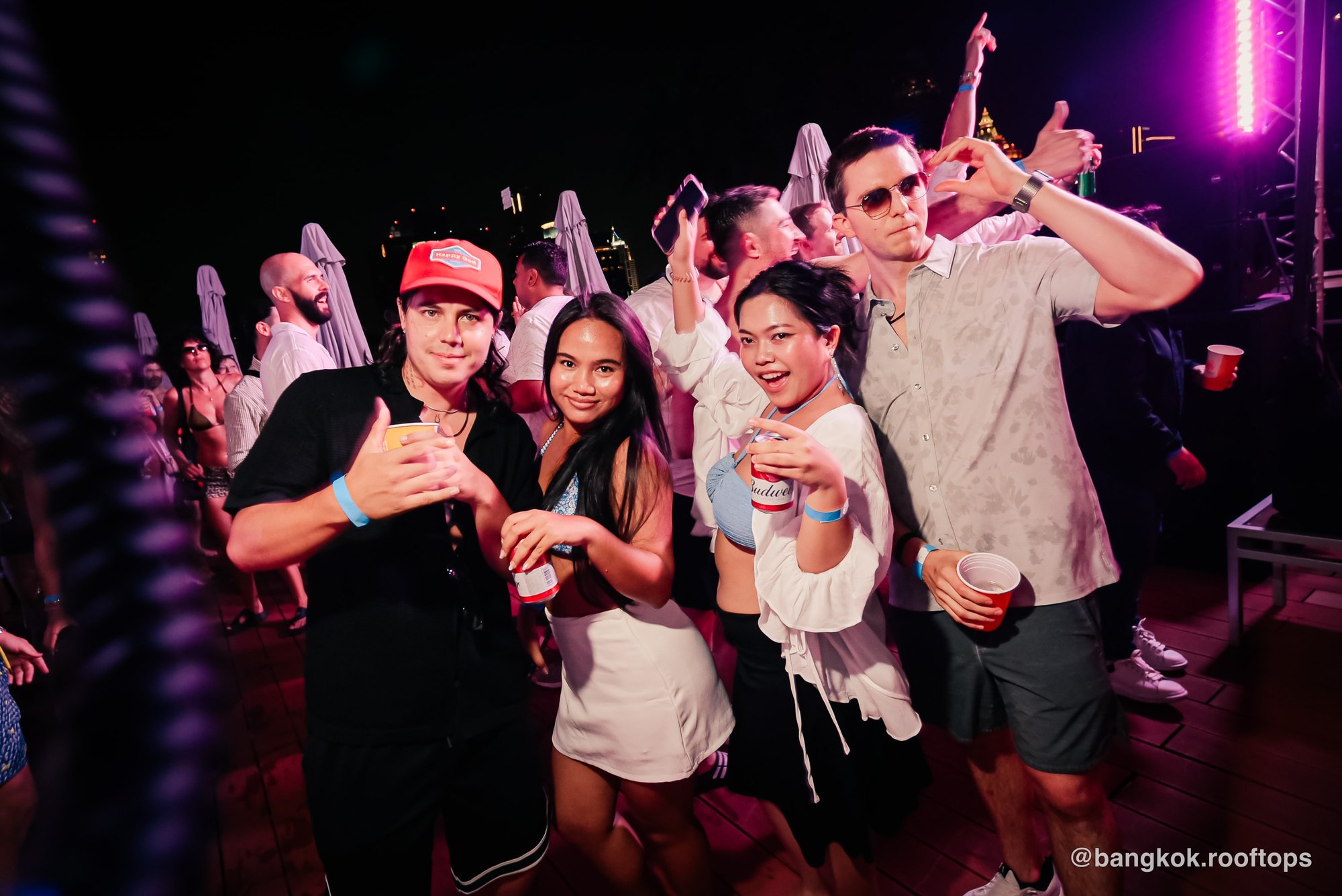 Friends enjoying drinks together at a Bangkok Rooftops pool party at Centara Grand