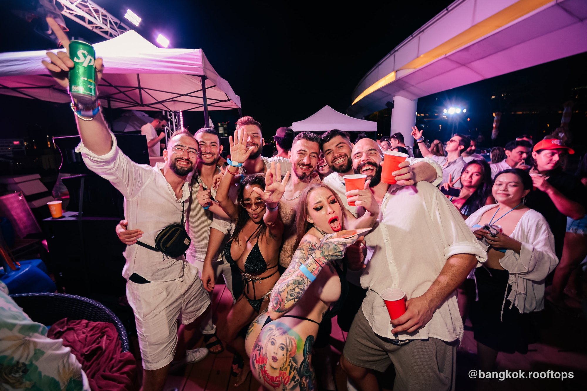 A group of friends celebrating together at a Bangkok Rooftops pool party