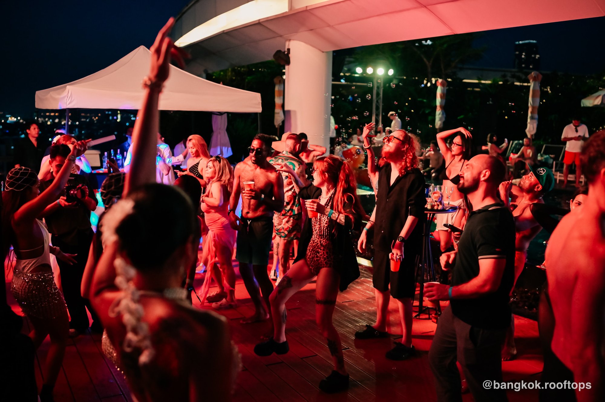 Night-time dancefloor in full swing at a Bangkok Rooftops pool party at Centara Grand