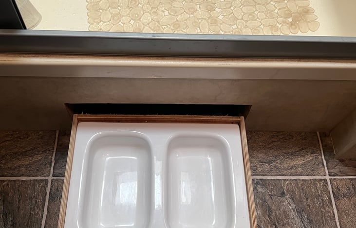 Food/water bowls for pets under the shower.