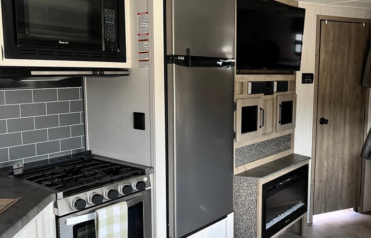 refrigerator, fireplace and tv