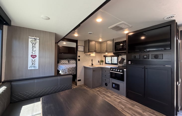Large dinette that converts to a bed, extra linen located under the TV cabinets. Empty pantry. The slide out gives lots of room to move around the trailer.