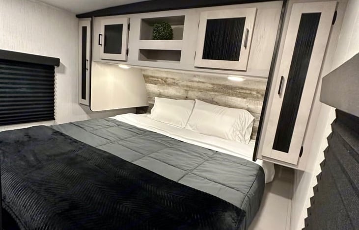 Master bedroom has a king size bed with ample  storage under and around. Phone charging stations on each side of the bed and reading lights.