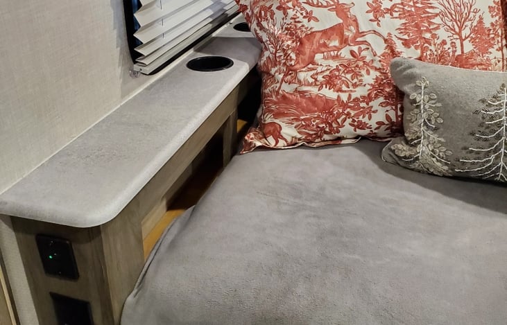 Drink holders, underneath storage, an outlet and USB are handy and close-by