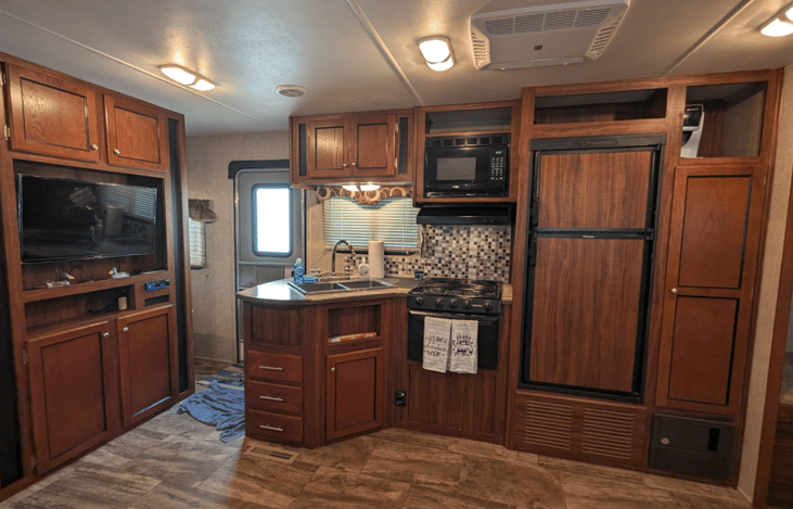 Kitchen is equipped with Double Bowl Sink, Microwave, 3 Burner Stove Top/Oven and Double Door Refrigerator. Keurig located above panty for renter use. Don't forget your pods.