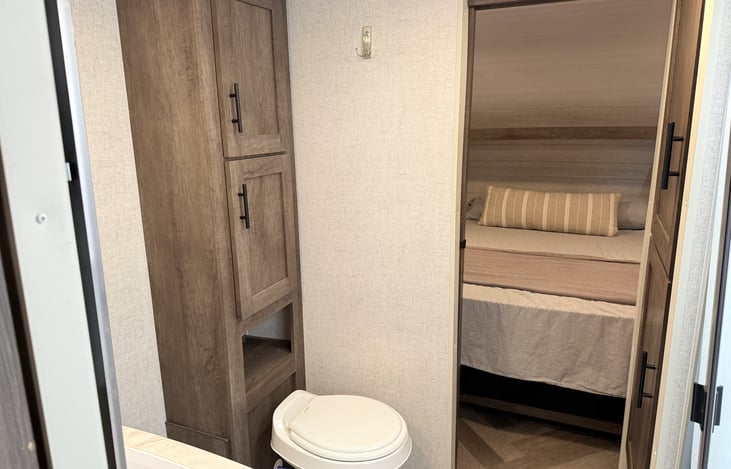 Roomy bathroom w/ double sliding pocket doors. Creates a nice space between the Master Bed and the rest of the camper