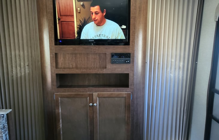 Curtain wall separates master bedroom from the living area. TV rotates around to watch from bed!