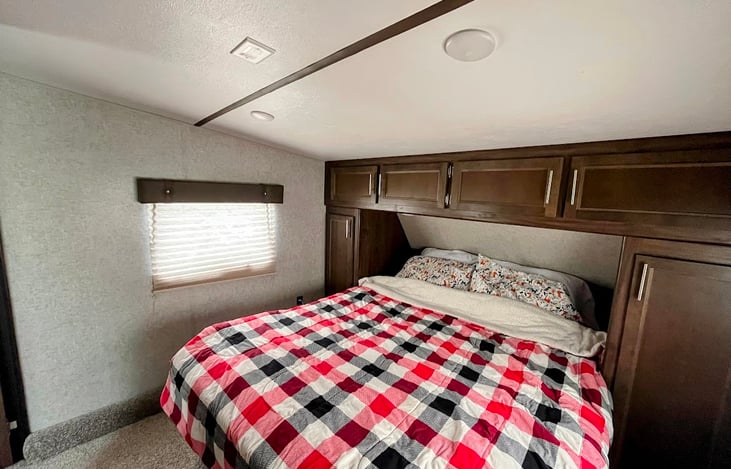 Main bedroom. Comfortable and sleeps two adults. Features closets, USB ports, and convenient outlets.