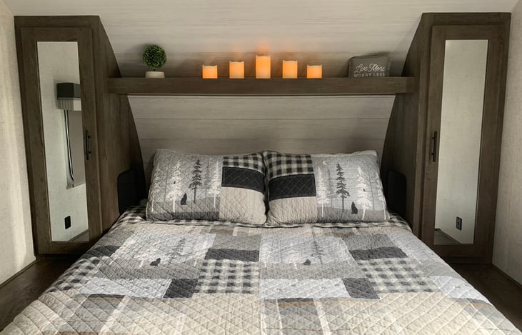 Bedroom is separated by a pocket door for privacy. There is a queen size bed with mirrored closets on each side of the bed. There is also a full size closet in the bedroom.