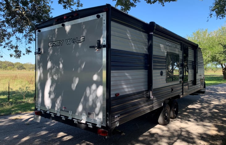 Outside right rear view. Note Toy Hauler back door and large awning