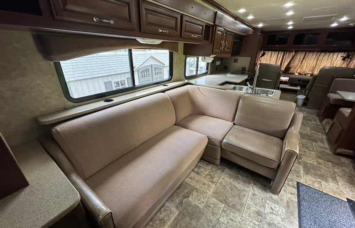 L-shaped couch with an extra seat. Great place to relax and watch a movie.