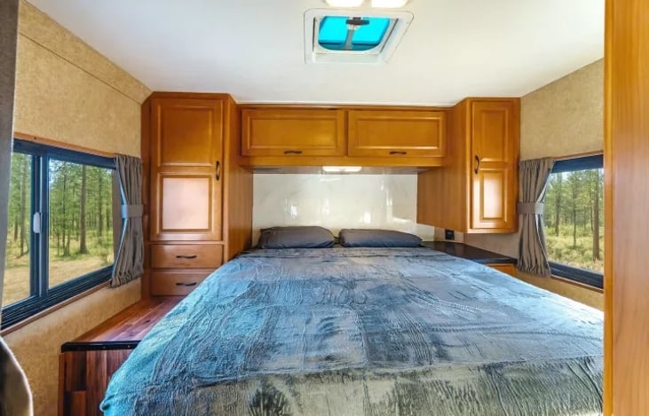 Comfortable queen bedroom in the Thor Majestic 28A — your private retreat after long drives, festival nights, or desert trips to Glamis and Dumont Dunes.