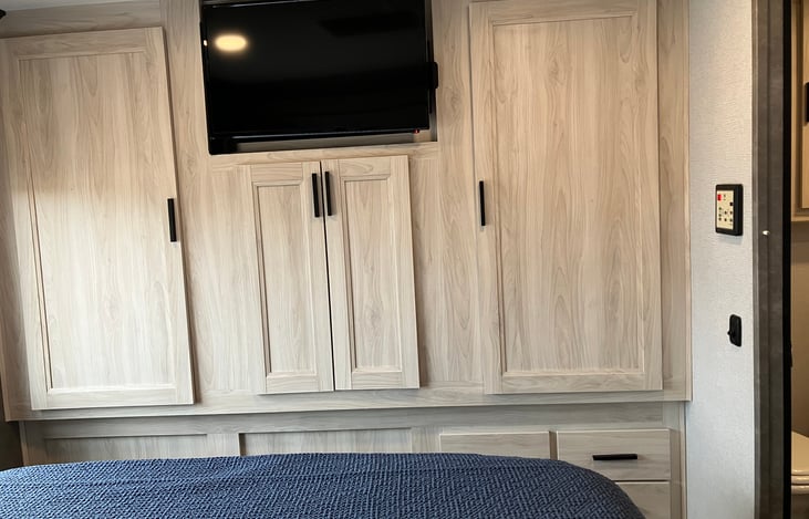 The bedroom has plenty of storage as well as a private tv.