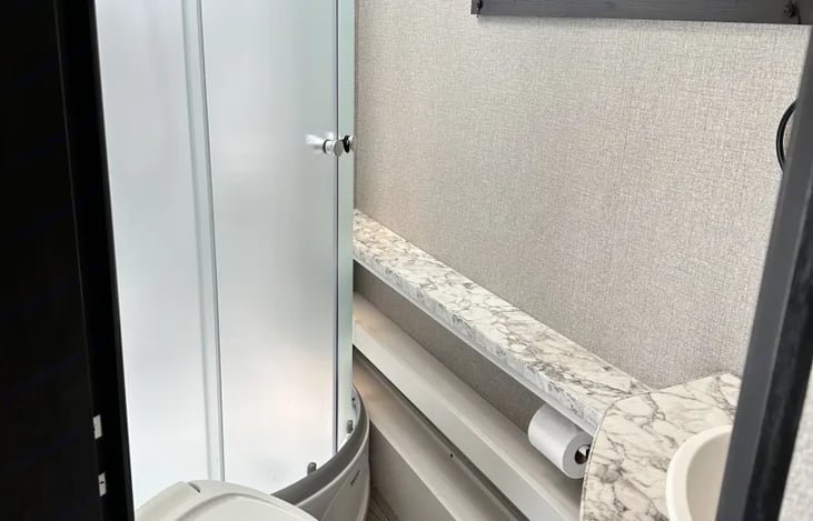 Bathroom shower, sink and toilet. Flush with plenty of water and RV toilet one ply paper only. Shower with detachable handle. Sink has under cabinet and above for store away personal products.
