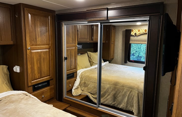 Full wardrobe closet with full length mirror.