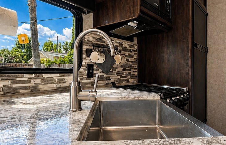 Modern kitchen with spacious countertops, deep sink, and full cooking setup