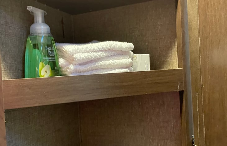 Bathroom cabernet it has three shelfs.