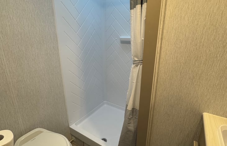 Shower has digital water heater to set the water temperature.