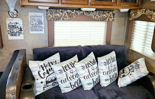 Large RV with outdoor kitchen, fireplace, and TVs