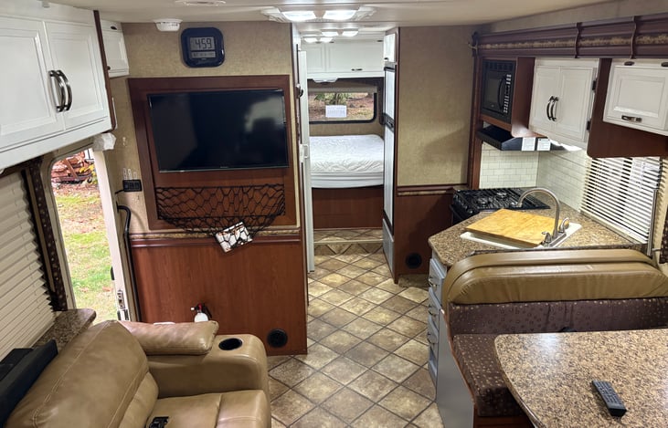 T.V with DVD and inputs in the living room, with a clock for you to ignore.