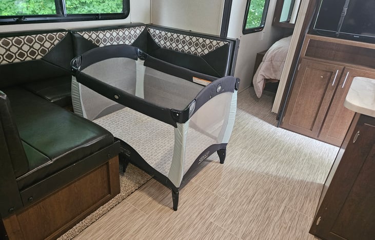 Large versatile dinette, can be used as dining table, couch (if you remove table) or double bed. Pack n play also fits nicely in this area.