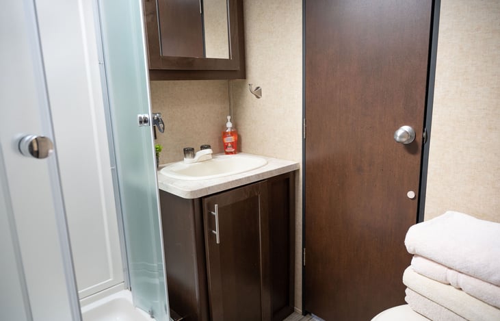 Full bathroom, flush toilet.  Access from Private Queen Bedroom and main part of camper