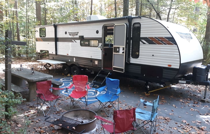 We set it all up for you, including lanterns, chairs for your group, a rug, and an outdoor prep table