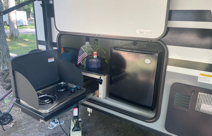Camp kitchen with mini refrigerator and slide-out 2 burner cooktop