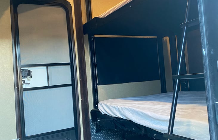 Bunk beds. Door allows access to patio.