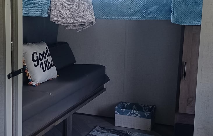 2nd room with queen bed converted to a couch for seating throughout the day