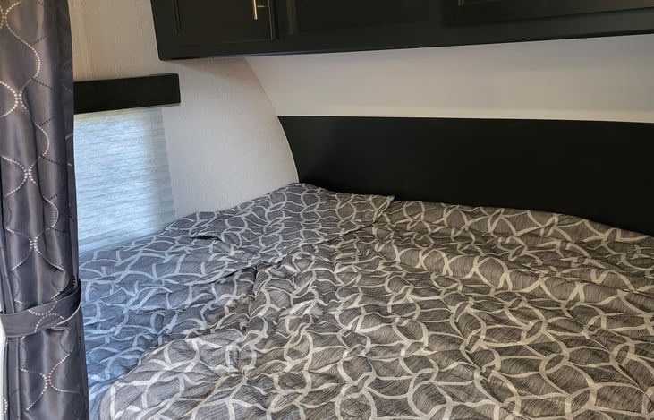 queen bed with foam topper and mattress pad