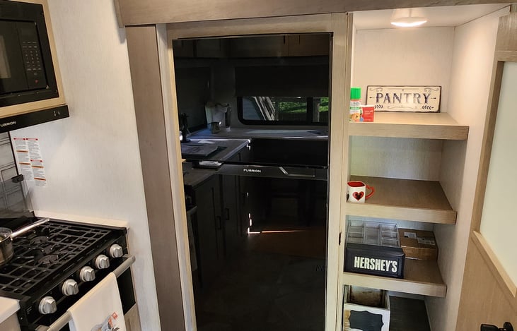 Large pantry for all storage needs with motion sensor lighting.