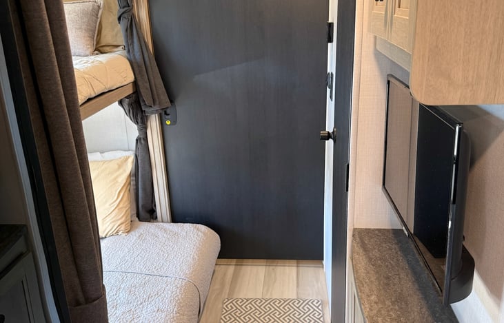 Hallway off the kitchen leading to the bath room, middle bunks with a privacy door to the master bedroom