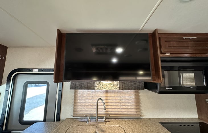 TV with a hidden cabinet behind it perfect for a pantry!