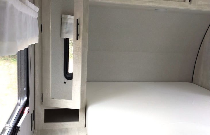 Comfy New Queen Mattress with lots of storage. 2 closets, above the bed cabinets and under the bed storage