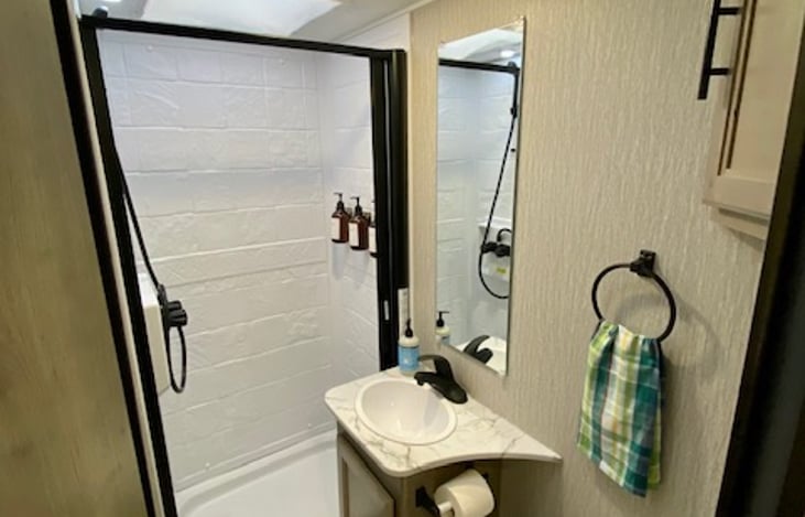 Spacious RV bathroom with shampoo, conditioner, and body wash included.  Retractable shower curtain