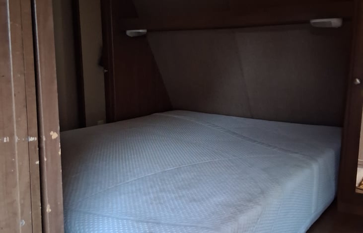 Bedroom with sliding doors for privacy. Memory foam queen sized bed, a tv/DVD player in room. Storage cabinets included in bedroom