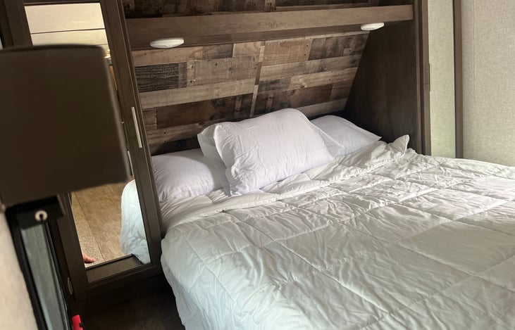 Queen bed behind privacy doors