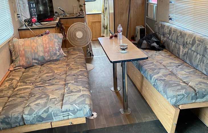 dining room with beds, showing one down and one couch that can go down into a bed as well