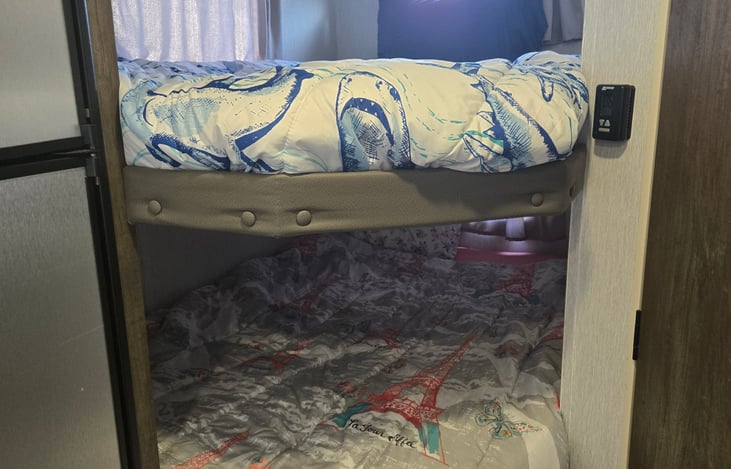 Kids bunks each with window and reading light