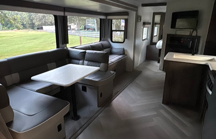 Actual Interior of the camper with tinted windows and 32” smart TV.
