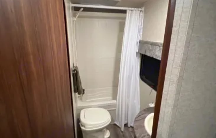 Bathroom includes a tub with a shower.