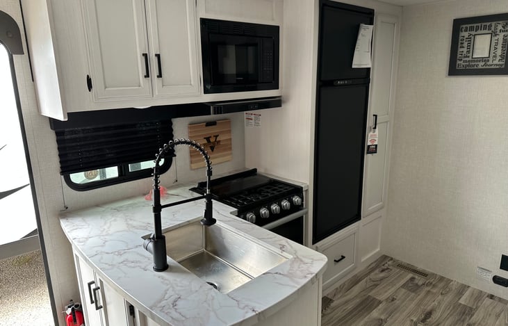 Full kitchen - microwave, stove, oven, fridge/freezer combo.