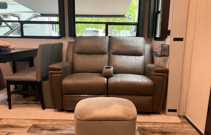 Dual electric recliners with storage ottoman.