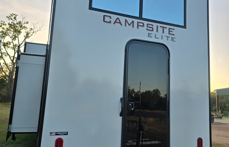 Back of the camper with a door to a full bathroom.