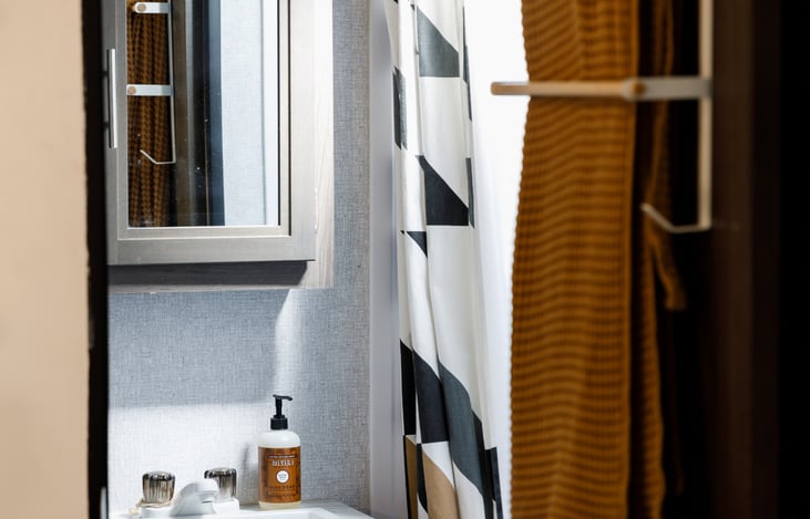 Bathroom with a toilet, shower and tub. Comes stocked with towels, wash cloths, hand soap, and shampoo/conditioner/body soap.