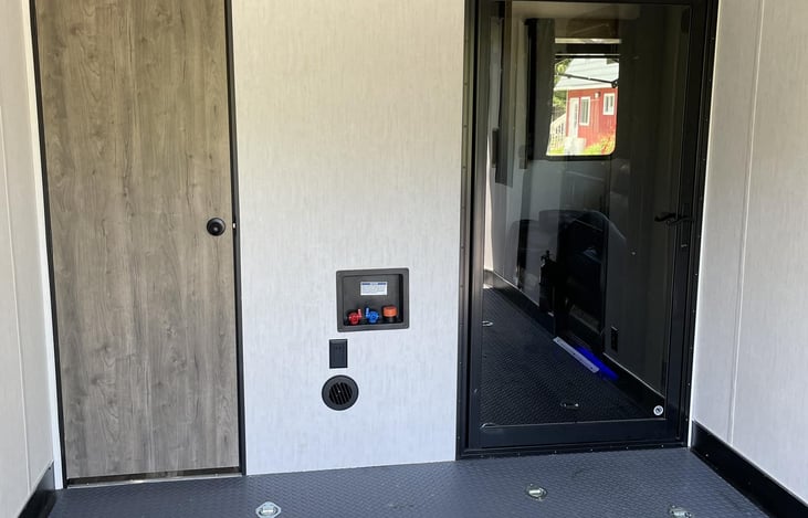 View of garage with spare bath, w/d hookups and door leading to living area.