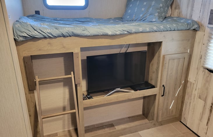 Bed 1 of 3 in the Bunkhouse as well as storage and Entertainment center.