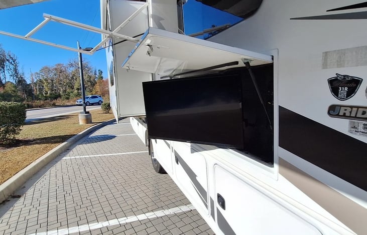 Outdoor TV with motorized, LED let awning.